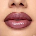 Glossy plum‑mauve lips wearing the Yasmin ColourPop Lippie Kit, delivering a full, high‑shine finish with defined edges in a clean studio close‑up, showcasing rich pigment and smooth texture.