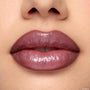 Glossy plum‑mauve lips wearing the Yasmin ColourPop Lippie Kit, delivering a full, high‑shine finish with defined edges in a clean studio close‑up, showcasing rich pigment and smooth texture.