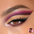 Gold glitter cut-crease eyeshadow with a sharp black wing and voluminous lashes on a brown eye, blended into rich purple and magenta, showcasing the Bratz x ColourPop Full Collection from the ColourPop Full Collection Set with a Sasha-inspired badge.