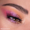 Close-up eye wears shimmer lavender blending into hot pink, peach, and a pop of yellow, lashes fanned and brow defined, showcasing the Prettiest in the Cosmos ColourPop Shadow Palette Set with sparkly, galaxy-inspired gradients.