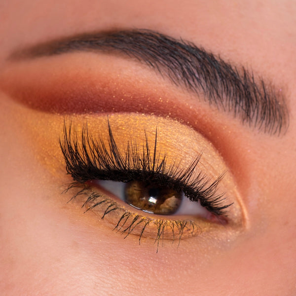 Shimmering honey-gold eyelid with a burnt-orange crease and long lashes, showcasing the Sweet as Hunny ColourPop Eye & Lip Set; warm golden glitter and a defined brow in a close-up beauty shot for radiant, everyday glam.