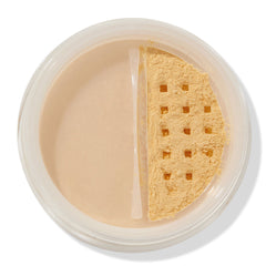 ColourPop No Filter Loose Setting Powder in Banana shown open, yellow-toned powder visible through a square-holed sifter in a clear round jar on a white background, used for brightening and setting makeup.