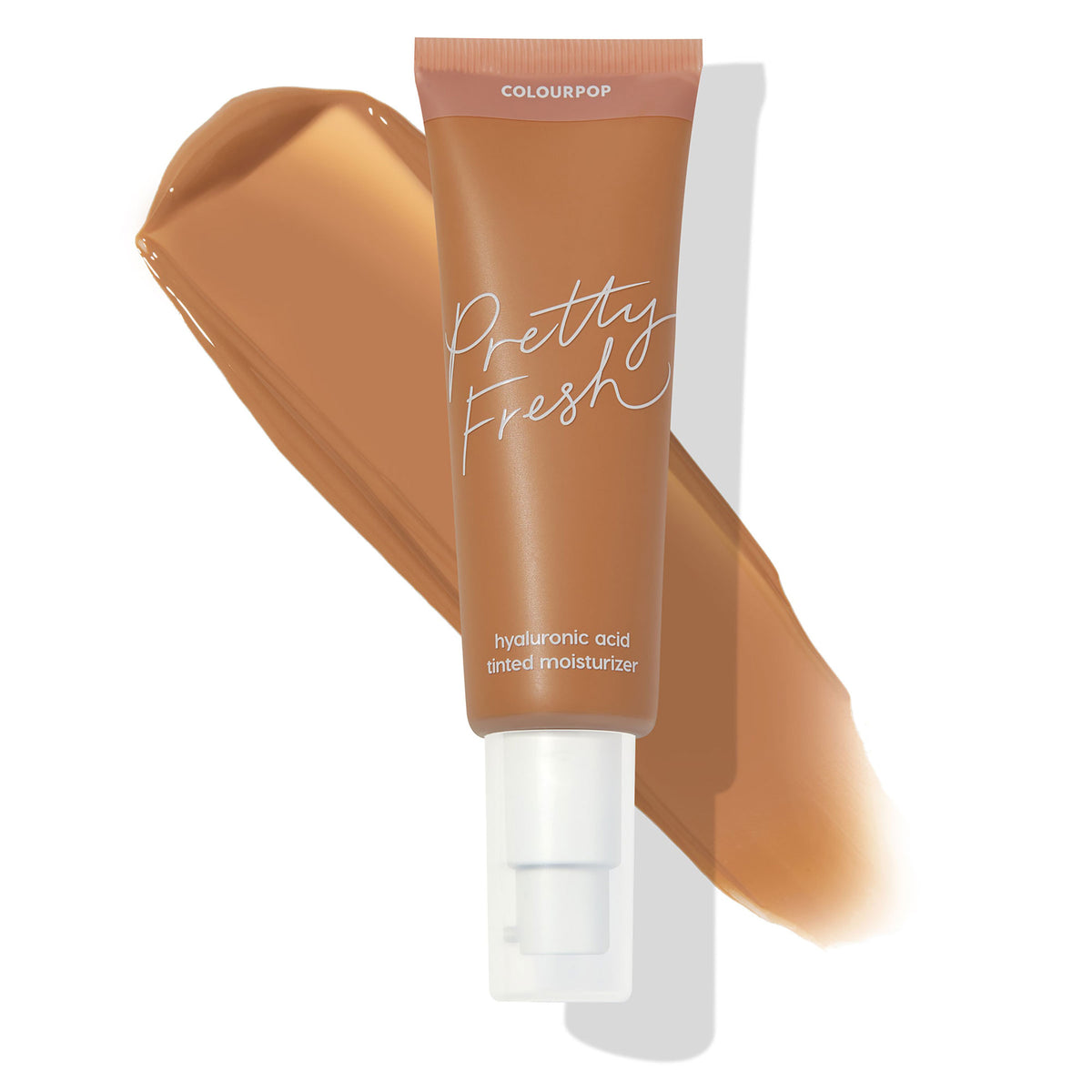 ColourPop Pretty Fresh Tinted Moisturizer tube in Medium Dark 14 W displaying a warm caramel swatch behind it, pump top attached; hyaluronic acid formula noted on the label against a clean white background.