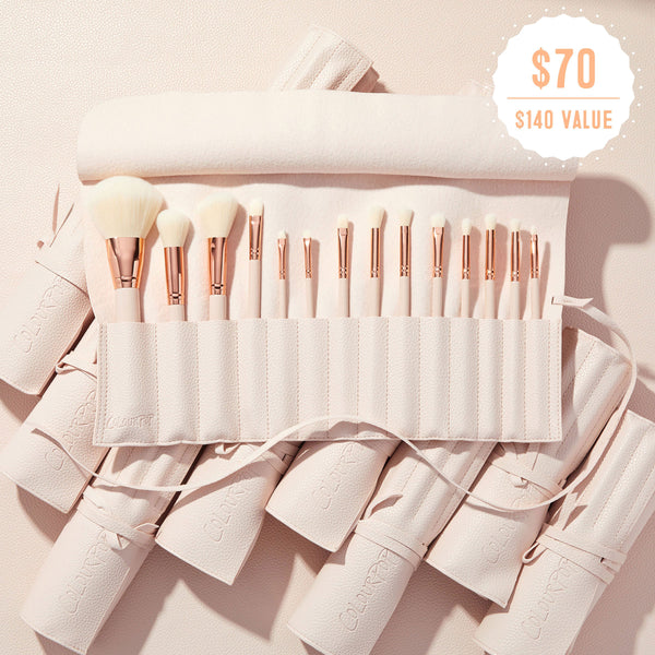 Crazy For Hue ColourPop Shadow Palette & Brush Set displaying a blush pink brush roll opened to reveal white‑bristle makeup brushes with rose‑gold ferrules, embossed ColourPop logo, on a soft pink surface with rolled cases and a $70 ($140 value) badge.