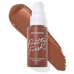 ColourPop Pretty Fresh Hyaluronic Hydrating Foundation in Deep Dark 205 N, a pump-top frosted bottle set over a rich deep neutral-brown swatch on white, showcasing the shade and silky texture; ColourPop Hyaluronic Hydrating Foundation.