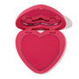 Heart-shaped Text Me pressed powder blush in a bright pink compact, opened to show the vibrant fuchsia pan and lip-shaped mirror, ColourPop Pressed Powder Blush for cheeks displayed on a white background.