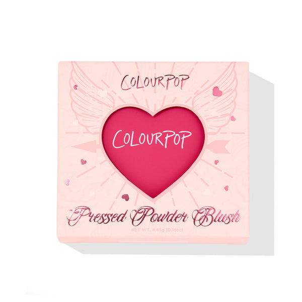 ColourPop Pressed Powder Blush in Text Me showcased in a blush‑pink compact, heart‑shaped window revealing a vibrant fuchsia pan, wing and heart graphics on the box, 4.45 g/0.16 oz, set on a white background.