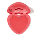 4ever Yours pressed powder blush opens to reveal a heart-shaped pink-coral pan inside a pink compact with built-in mirror on a white background; ColourPop Pressed Powder Blush offering soft, buildable cheek color.