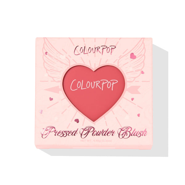 ColourPop Pressed Powder Blush, 4ever Yours, shown in a heart-shaped pan through a pale pink box with winged-heart graphics; warm rosy pink shade, 4.45 g/0.16 oz compact for buildable matte cheek color.