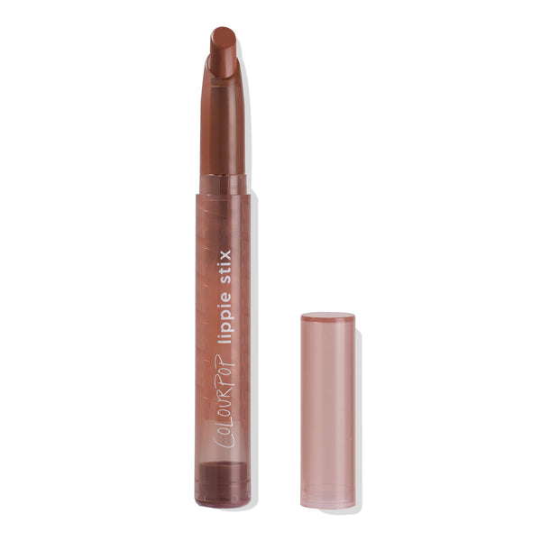 ColourPop Lippie Stix in Sassy standing uncapped, twist-up bullet raised to reveal a warm terracotta-brown lipstick, housed in a mauve tube with the clear cap set beside it on a clean white background.