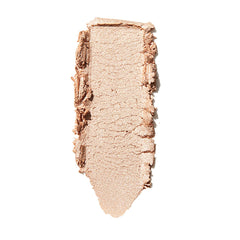 ColourPop Lunch Money Super Shock Highlighter swatch - soft champagne-beige shimmer - spread in a single swipe on a white background, showing its creamy texture and luminous metallic glow for cheek and brow bone highlighting.