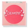 Staycation ColourPop Pressed Powder Blush compact, closed, showing a vivid coral-pink round pan under a clear square lid with white sparkle graphics and ColourPop logo, shot on a white background with a soft shadow.