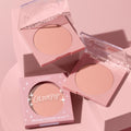 Why Hello ColourPop Pressed Powder Blush compacts showing a soft peach matte shade, one boxed and two open with clear star-etched lids, styled on a monochrome pink pedestal background.