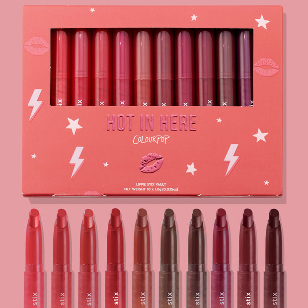 Heat Warning ColourPop Lippie Vault Set displaying 10 Lippie Stix shades from coral and pink to red, mauve, and deep berry, arranged in a pink “Hot in Here” box with stars and lightning bolts, with the open lipstick bullets shown below.