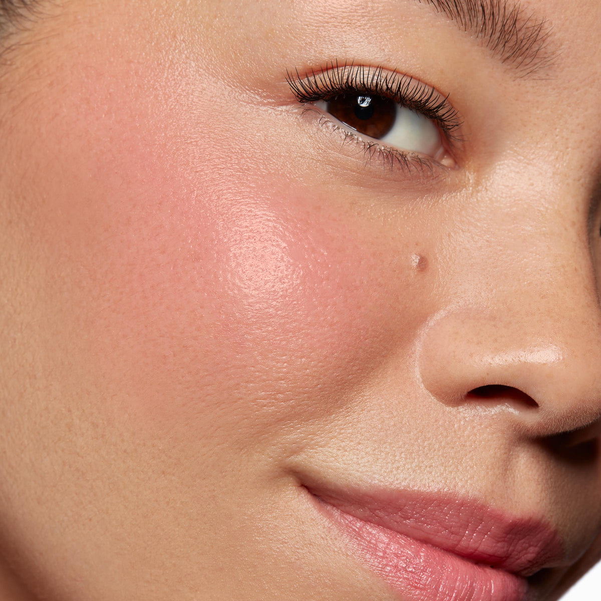 Cheek and lips wearing Adore You ColourPop Lip and Cheek Balm, a multi-use cream balm, showing a sheer rosy pink tint and dewy shine on skin; buildable, natural finish in a close-up swatch.