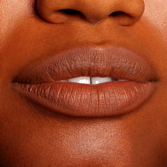 Lips softly parted and defined in a warm brown nude, wearing ColourPop Truth or Bare Lippie Pencil, showing precise outline and a smooth, creamy matte finish in a tight close-up beauty shot.