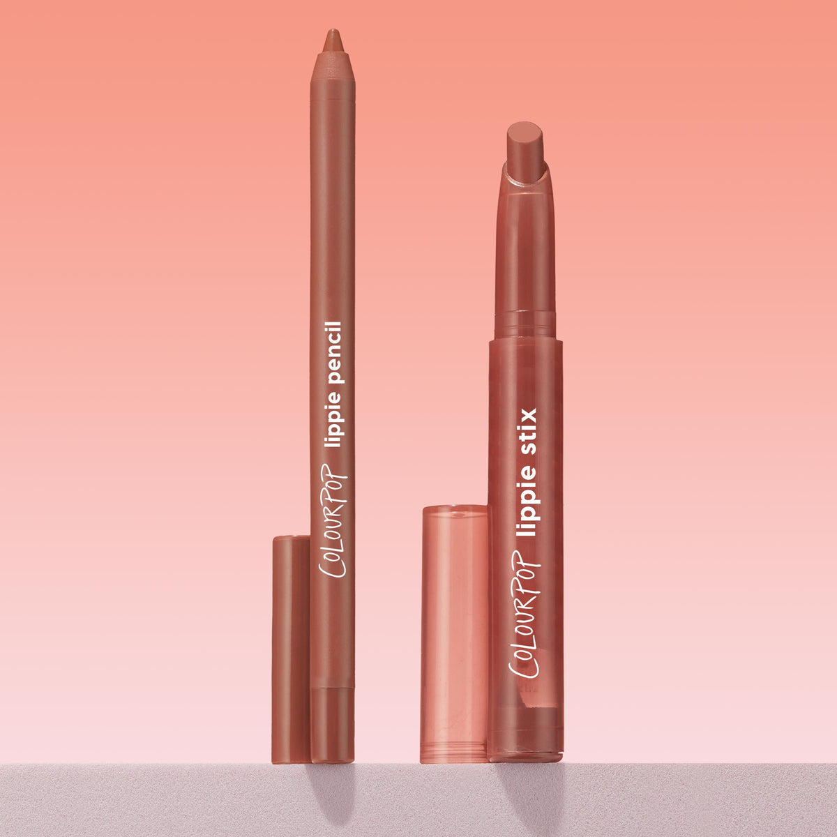 ColourPop Lippie Stix + Pencil Set in Stripped Down shown uncapped - nude-brown lip pencil and matching Lippie Stix standing upright with clear caps beside them - on a soft pink gradient background, ideal for precise lining and creamy coverage.