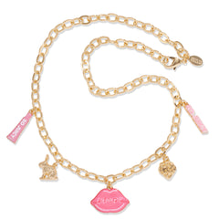 Brooklyn Charm x ColourPop Necklace draped on a white background, featuring a gold-tone chain with lobster clasp and enamel charms: pink lips reading 'ColourPop', So Juicy tube, bunny, strawberry, and pink bubble-letter bar.