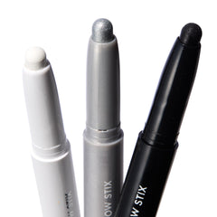 Totally Wicked ColourPop Shadow Stix trio showing exposed tips - matte white, metallic silver, and black shimmer - standing upright in white, gray, and black twist-up tubes on a bright white background.