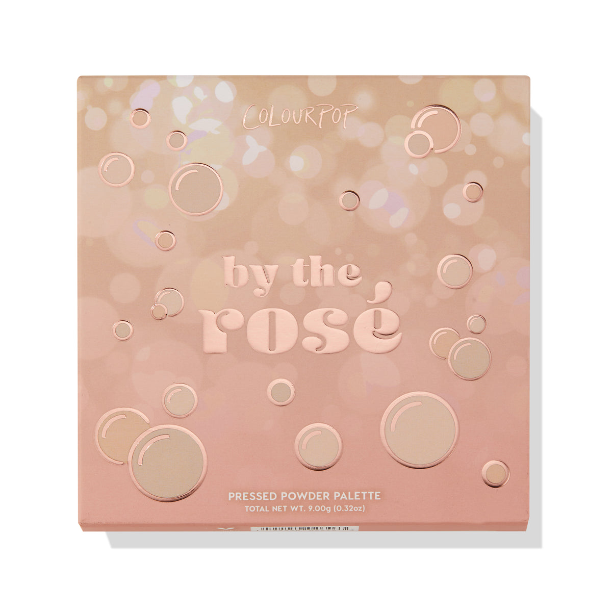 By The Rosé ColourPop Shadow Palette lies closed, showing a blush-pink square case with rose-gold bubble accents and debossed lettering, labeled Pressed Powder Palette, 9.0 g/0.32 oz, on a white background.