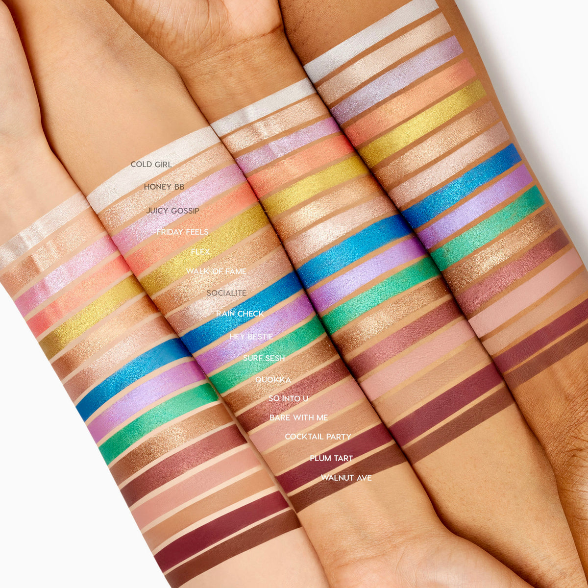 Juicy Gossip ColourPop Shadow Stix swatched in a clean stripe across four arms from light to deep skin tones, showcasing creamy, long‑wear payoff next to the full lineup of ColourPop Shadow Stix shades on a studio white backdrop.