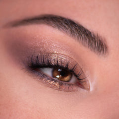Glittering bronze and mauve eyeshadow blends on a brown eye with fluttery lashes and a groomed brow, created using the 11:11 Shadow Palette, a ColourPop Shadow Palette delivering day-to-night metallic sparkle.