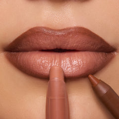 Glossy nude lips wear ColourPop Lippie Stix in the shade In the Nude, applied with a creamy bullet while a brown liner defines the edges; tight beauty close-up highlighting smooth payoff and precise lip contour.