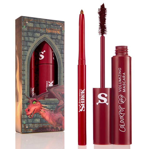 Dragon’s Keep Crème Gel Liner twisting up with a shimmery gold tip, shown uncapped beside a Shrek-themed castle box with dragon art and a matching red mascara; ColourPop Crème Gel Liner in red packaging with white logos.