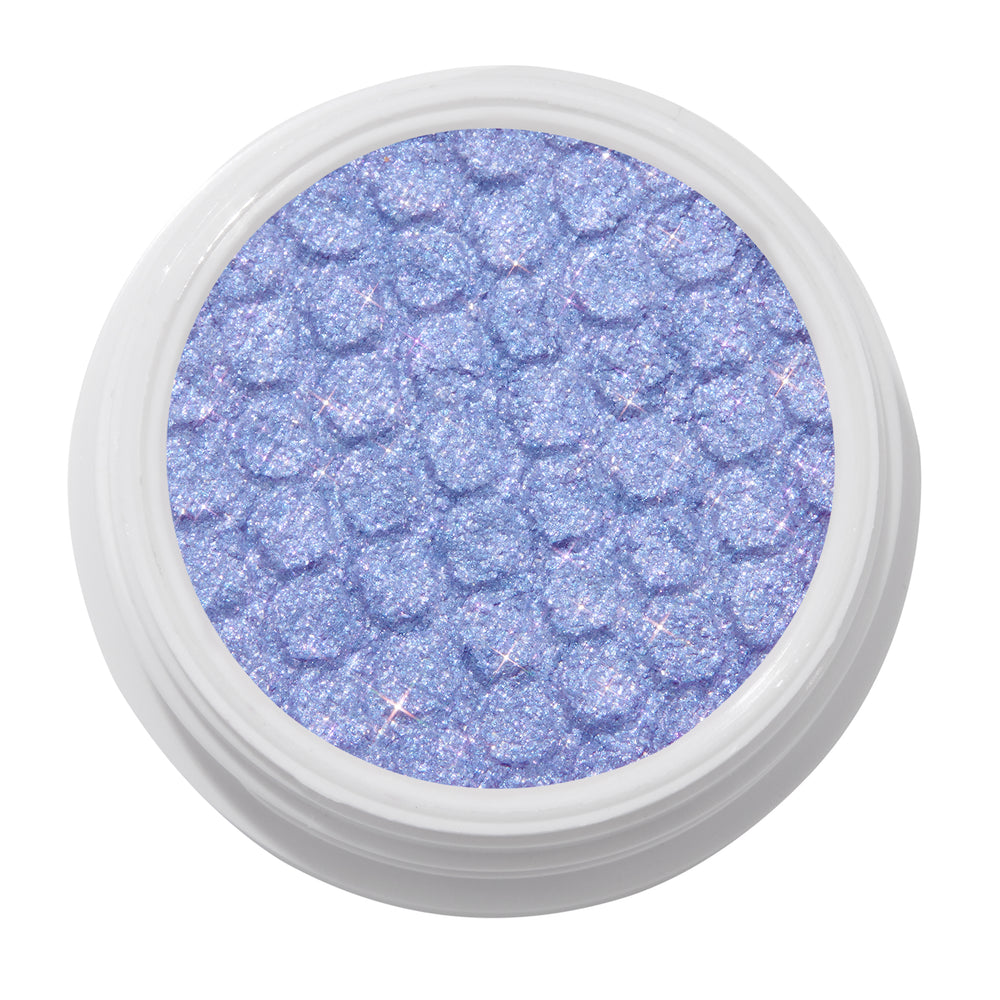 Dream Much shimmering lavender ColourPop Super Shock Shadow, a glittery lilac eyeshadow with bouncy dimpled texture, shown in a white round pot on a clean white background.