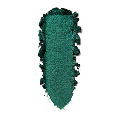 Empire Super Shock Shadow by ColourPop swatched in a single elongated smear, showing a rich metallic emerald green with fine shimmer and soft crumbled edges on a white background to highlight texture and pigment payoff.