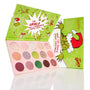 ColourPop How the Grinch Stole Christmas shadow palette showcasing 15 festive matte, shimmer, and glitter shades, opened to reveal pink pans beside bright green holiday packaging with the Grinch in a Santa hat and Whoville artwork.
