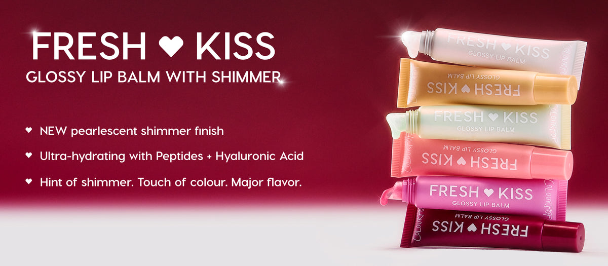 Colourpop Fresh Kiss Glossy Lip Balm with Shimmer tubes stacked in pastel and deep shades on a red gradient background, highlighting new pearlescent finish, hydrating peptides, and hyaluronic acid benefits.