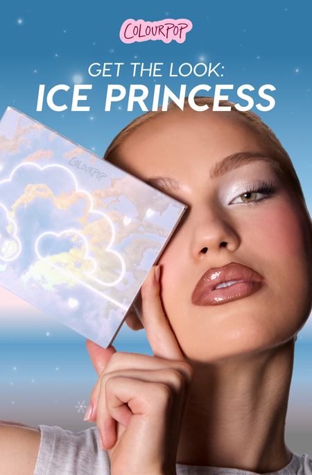 Model wears shimmery icy eyeshadow and glossy lips while holding a holographic cloud-themed Colourpop palette beside her face against a dreamy night-sky backdrop with text promoting the Ice Princess makeup look.