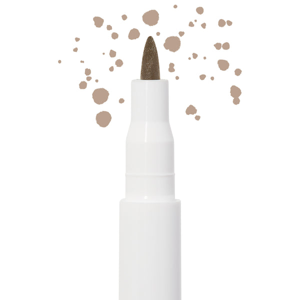 Soft Brown freckle pen by Colourpop with a fine felt tip applying natural soft brown dots, shown close up against a white background to highlight precise faux freckle makeup for the face.