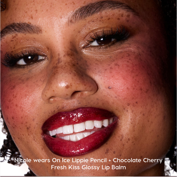 Close-up of a smiling model wearing Colourpop Peach Mochi Fresh Kiss Glossy Balm, showing high-shine berry-toned lips that highlight the Lip Gloss & Lip Oil finish against glowy, freckled skin.
