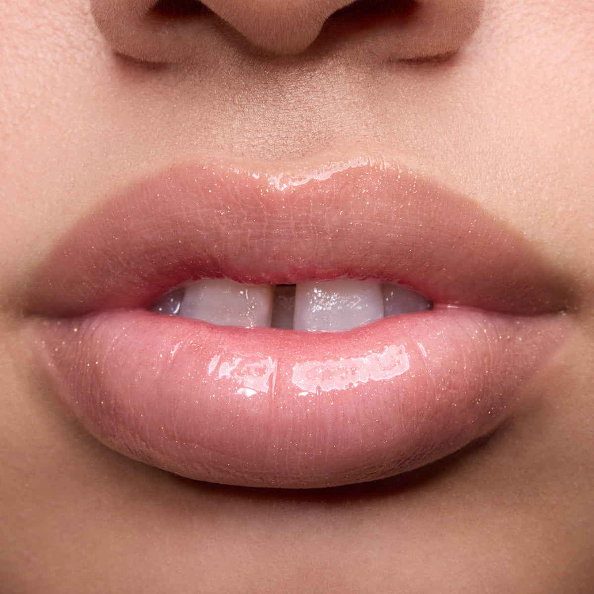 Close-up swatches of Colourpop Peach Mochi Fresh Kiss Glossy Balm on models’ lips, showing sheer peachy shimmer and high-shine finish, highlighting how this Lip Gloss & Lip Oil hybrid looks on different skin tones.