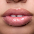 Close-up of models’ lips wearing Colourpop Fresh Kiss Glossy Balm in Raspberry Crème, showing sheer pink shimmer Lip Gloss & Lip Oil finish on different skin tones against a simple studio background.