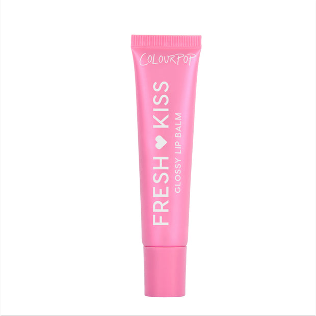 Colourpop Raspberry Crème Fresh Kiss Glossy Balm standing upright against a white background, showing its bright pink squeeze tube packaging and bold white logo, promoting hydrating Lip Gloss & Lip Oil shine for soft, glossy lips.
