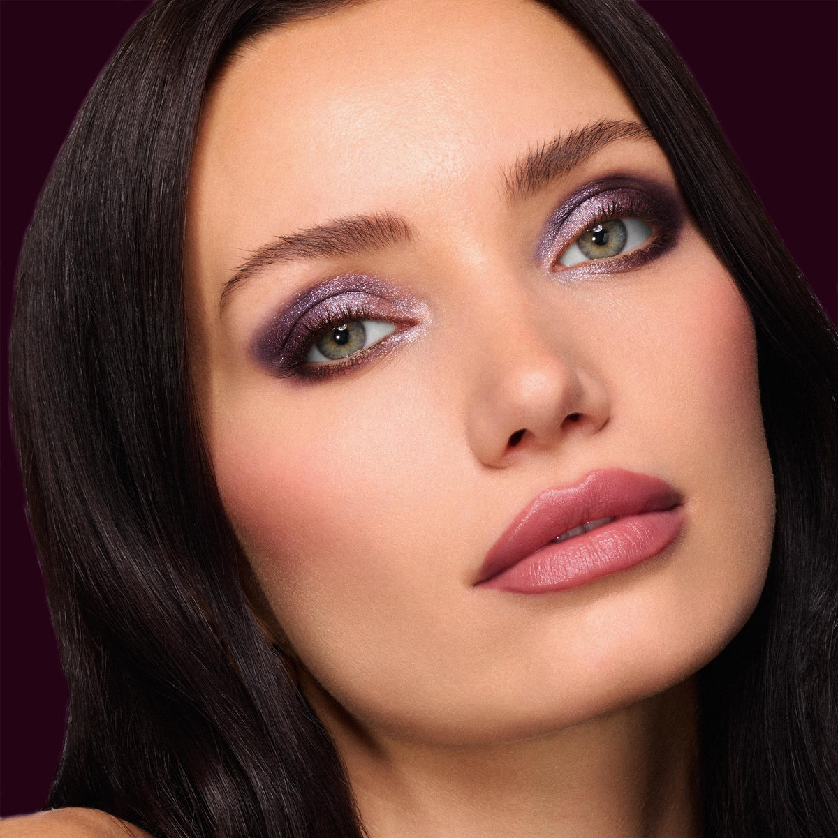 Defined mauve lips lined and filled with Secret Kiss ColourPop Lipstick & Lip Pencil Set, shown in a studio close-up with icy plum shimmer eyeshadow, smooth medium skin, and dark hair against a deep burgundy background.