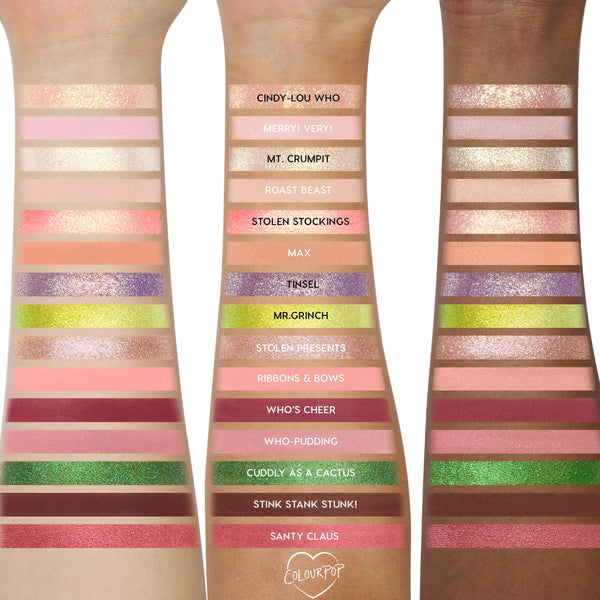 ColourPop How the Grinch Stole Christmas shadow palette swatched on three forearms, showing 18 labeled shades - neutrals, pinks, cranberry, purple, metallic golds, lime green, and deep brown - demonstrating payoff across light to deep skin tones.