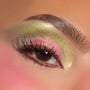 Shimmery chartreuse and rosy pink shadows blend across a close-up eyelid with fluttery lashes and a defined brow, showcasing the ColourPop How the Grinch Stole Christmas Shadow Palette holiday eye look.