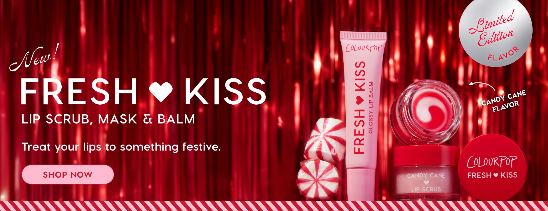 Colourpop Fresh Kiss holiday lip care set showcasing a glossy lip balm tube, candy cane lip scrub jar, and red‑white swirl lip mask, posed with peppermint candies against red tinsel, promoting a limited‑edition candy cane flavor.