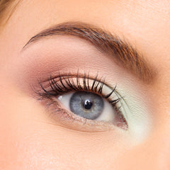 Close-up of a fair-skin eye with soft mint and peach shadow from the Best of Both Worlds palette