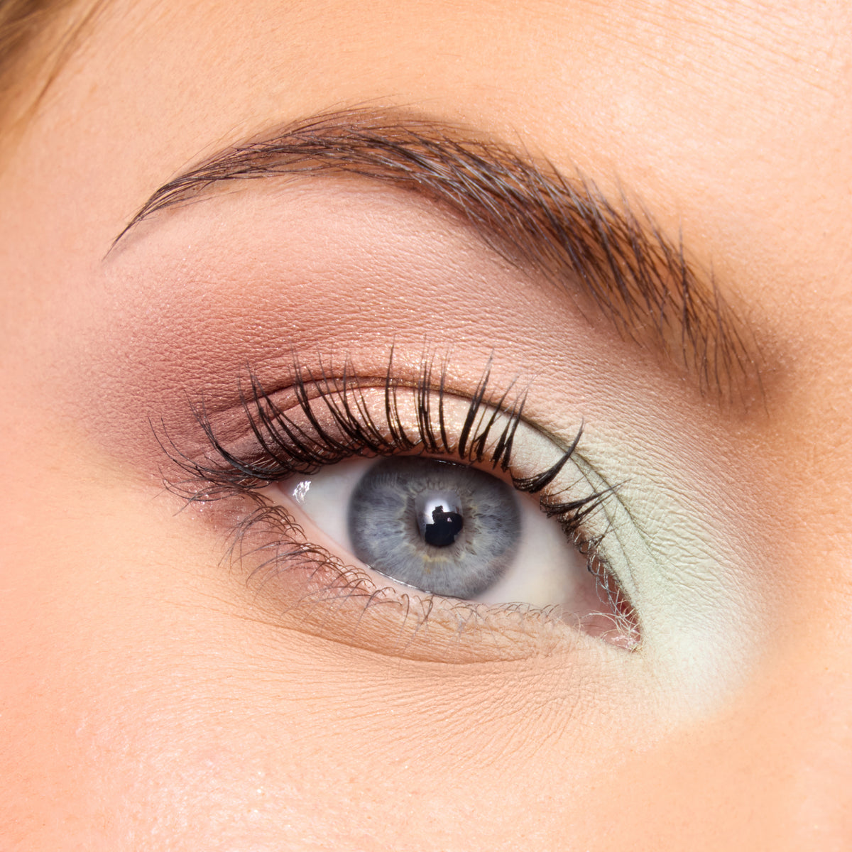 Close-up of a fair-skin eye with soft mint and peach shadow from the Best of Both Worlds palette