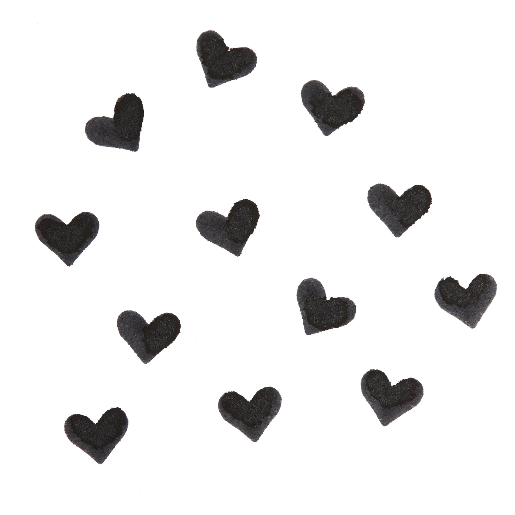 Black heart-shaped swatches stamped by the Heart Face Stamp, showing opaque, crisp pigment on a white background; ColourPop Face Stamp swatch pattern highlighting payoff.