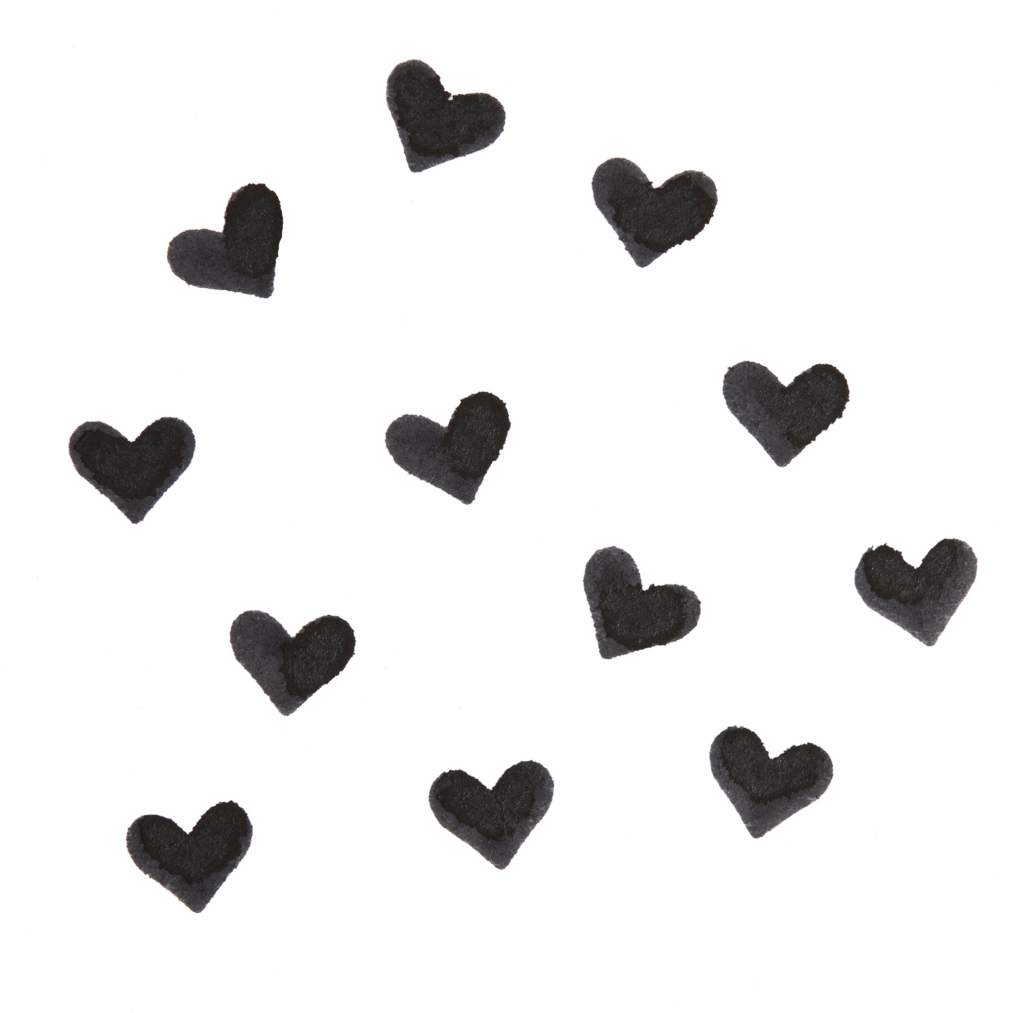 Black heart-shaped swatches stamped by the Heart Face Stamp, showing opaque, crisp pigment on a white background; ColourPop Face Stamp swatch pattern highlighting payoff.