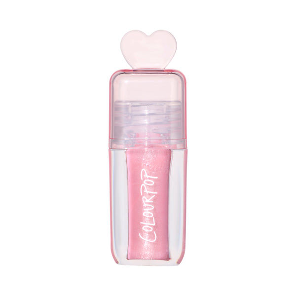 ColourPop 2 Die 4 Ultra Glossy Lip standing upright against a white background, showing its shimmery light pink Heart to Get shade in a clear pink tube topped with a translucent heart-shaped cap for cute, high-shine lip gloss looks.