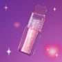 ColourPop 2 Die 4 Ultra Glossy Lip in a clear tube with pink shimmer gloss and heart-shaped cap floating against a dreamy purple Heart to Get themed background with soft sparkles.