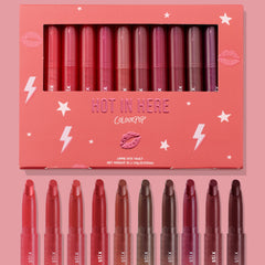 Hot in Here ColourPop Lippie Stix vault showcasing 10 creamy shades - from rosy pinks and corals to berries and deep browns - arranged in a coral box with star and lightning graphics, windowed lid, and matching bullet tips displayed below.