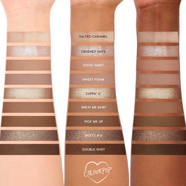 Deja Brew ColourPop Shadow Palette swatches run across three forearms, showcasing ten neutral matte and shimmer eyeshadows - Salted Caramel to Double Shot - labeled and ranging from creamy beige to espresso brown for everyday eye looks.